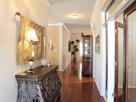Entrance has French Doors opening to Study--custom stained wood with transom and side lites