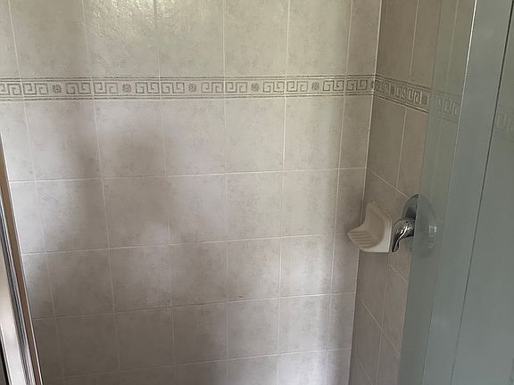 Updated shower tile floors and standing shower in master bathroom
