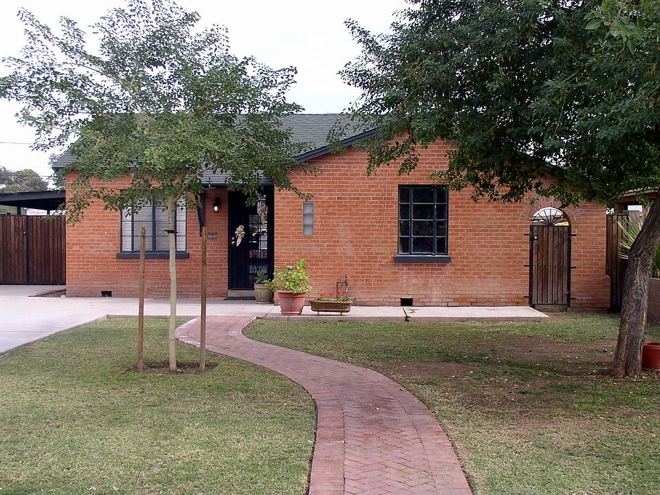 A subtle brick walkway and mature vegitation welcome you