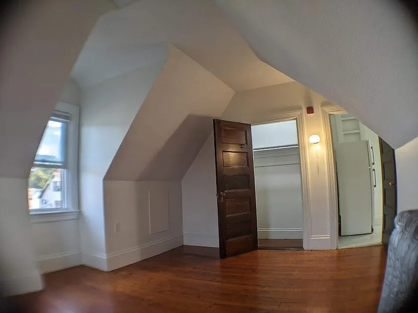 Large bedroom Room,Walk In Closet, left door. Window facing property parking lot.