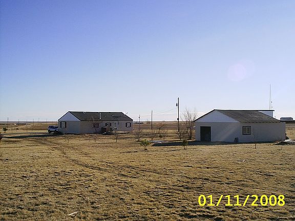View of back of house and 5 car garage.