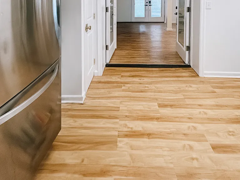 Clean hallway space with closet storage and updated flooring.