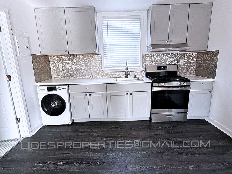 Kitchen with all in one in unit washer dryer, and new stove/oven