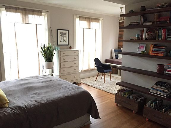 primary bedroom view from doorway with built-in shelves and alcove