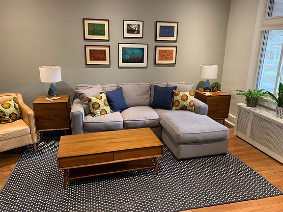 The living room is immediately off of the entryway. The big window provides bright morning light.