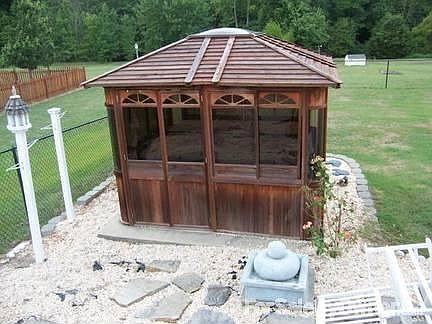 Relax in the hot tub
						:
						Walk out on the back porch to your gazebo enclosed hot tub, installed in 2008!