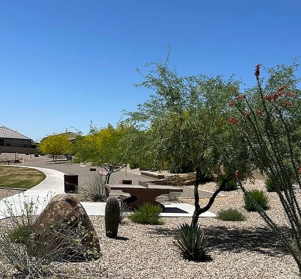 A covered picnic area, swings, and ping-pong