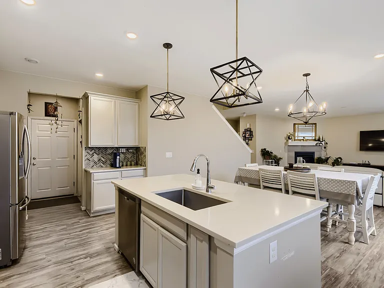 Light, bright and airy with light gray counters, white countertops and a rustic gray-white-washed floors