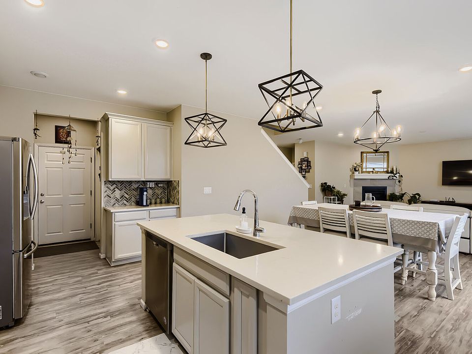 Light, bright and airy with light gray counters, white countertops and a rustic gray-white-washed floors