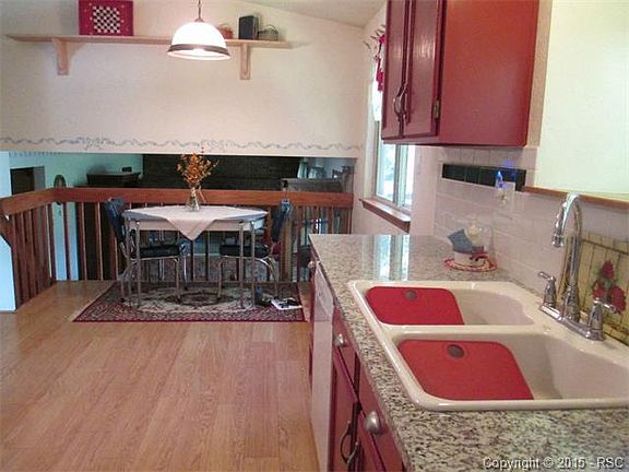 Spacious Kitchen with Granite Counters, eat-in area, hardwood floors.  Opens to 