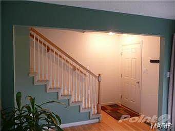 Foyer with wood entry and down the hall to the dining area.
