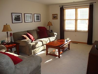 Sunny living room with new carpet, paint and tile at the entrance