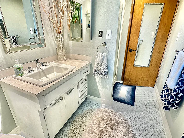 One bathroom with towels and starter supplies for your use. Heater fan and vent are just outside of the shower stall.