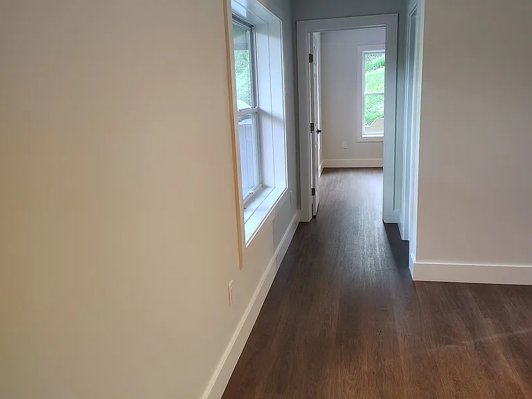 View of hall from living room to bathroom then bedroom.