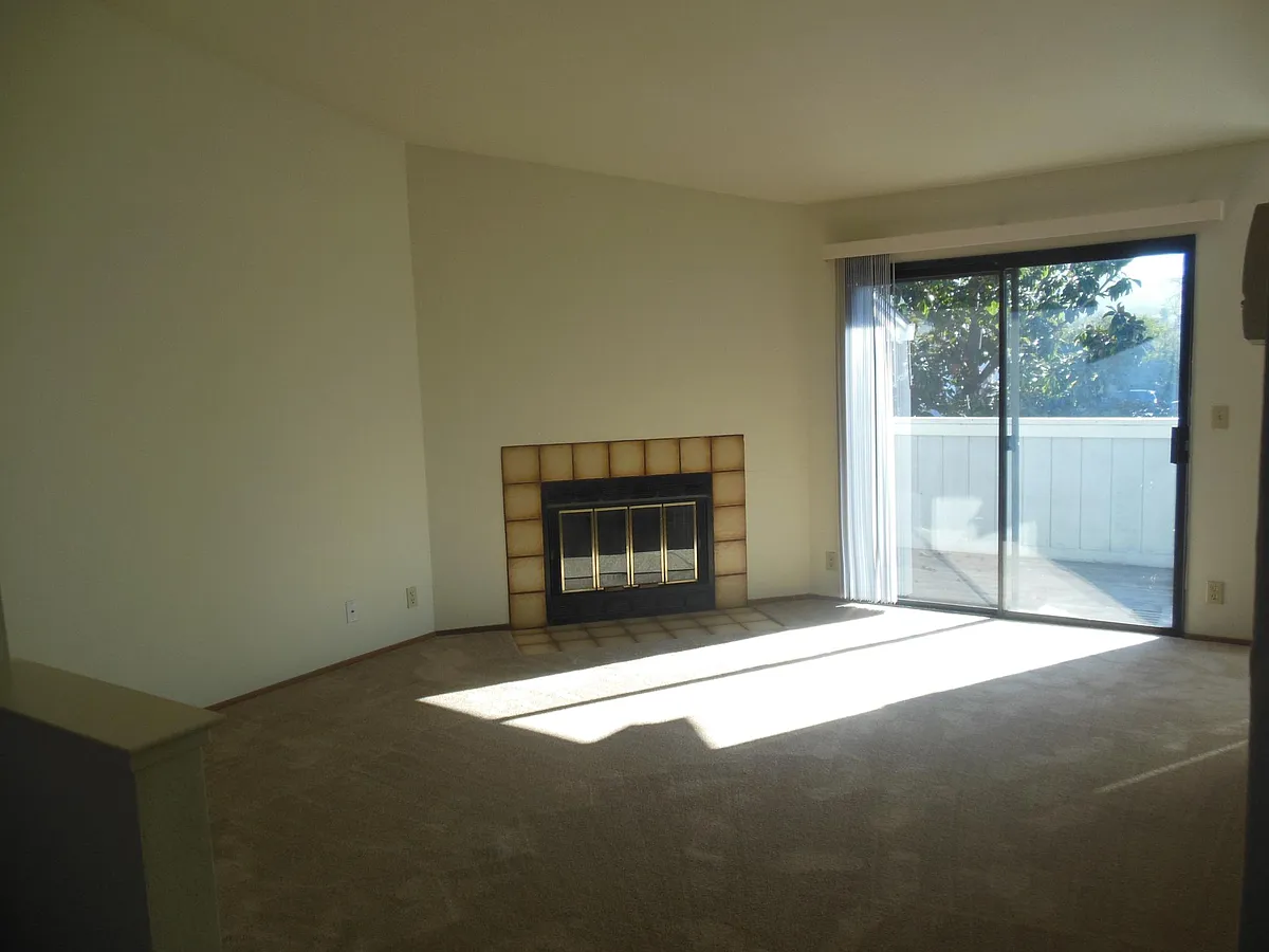 Spacious living room with fireplace and slider out to balcony. - 193 Mohave Cmn
