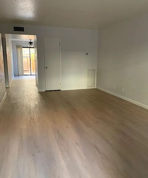 Large living room area with beautiful vinyl plank flooring