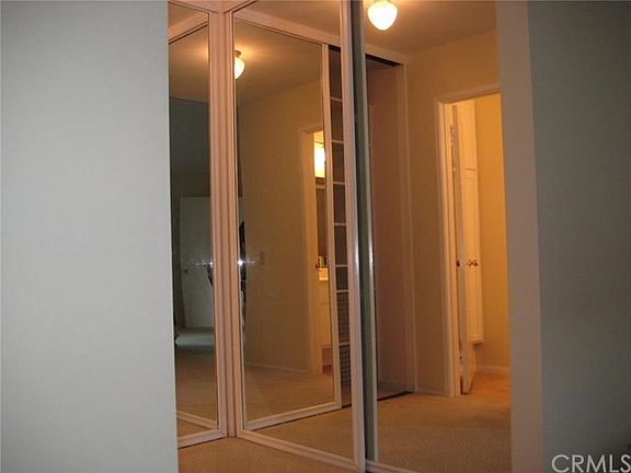 Double mirrored closet doors with custom organizer from closet world inside.