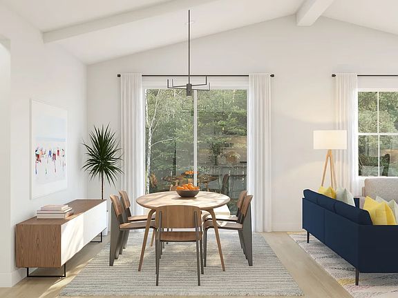 Dining area with vaulted ceiling and white ceiling beams