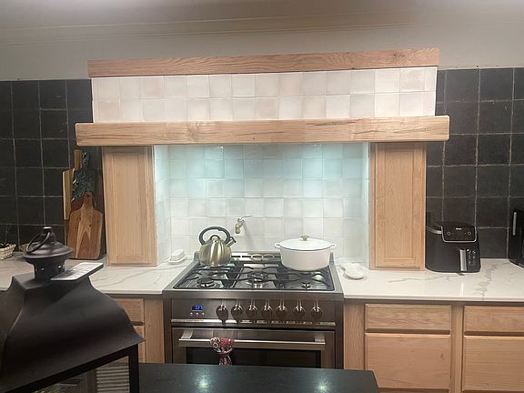 newly remodeled kitchen features 5 burner industrial gas stove and oven w/ exhaust