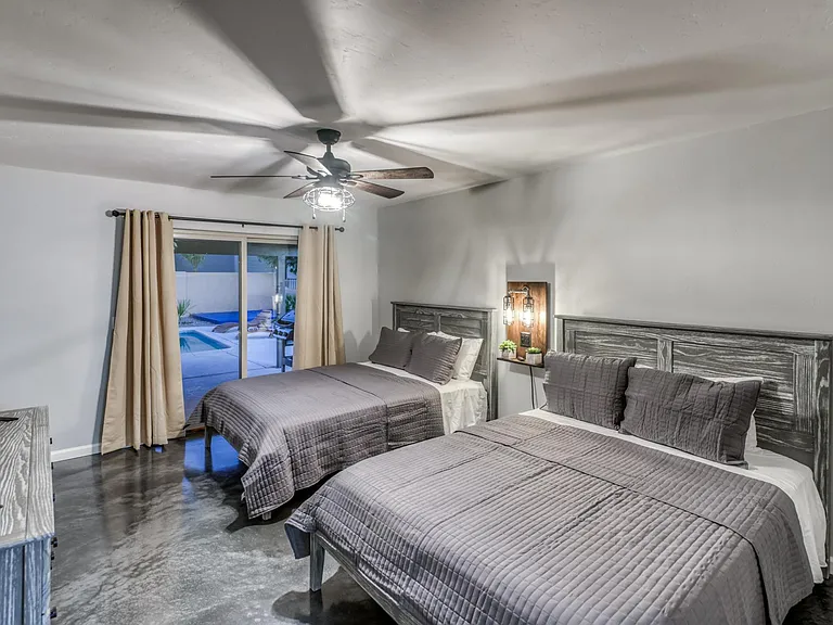Spacious oversized Master bedroom with King or dual beds layout potential, large sliding glass door to backyard, and upgraded flooring.