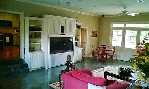 Family room with slate floors and built-in bookcases