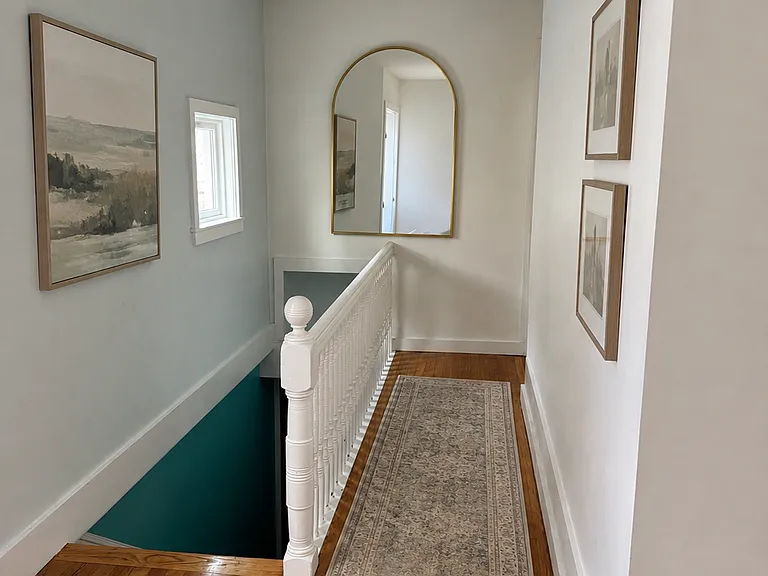 Virtually staged by adding a rug, mirror and 3 paintings.