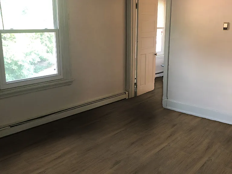 Large living room with closet, high ceilings, and great natural light.