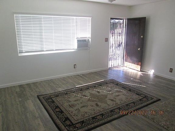 #4 / Front Living room with iron security door. New mini blinds, ceiling fans and and air conditioners in each room