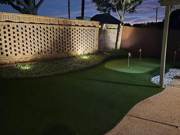 Back yard and putting green at night
