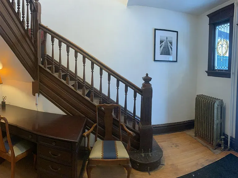 Front entrance with executive desk, stained glass window and charming woodwork