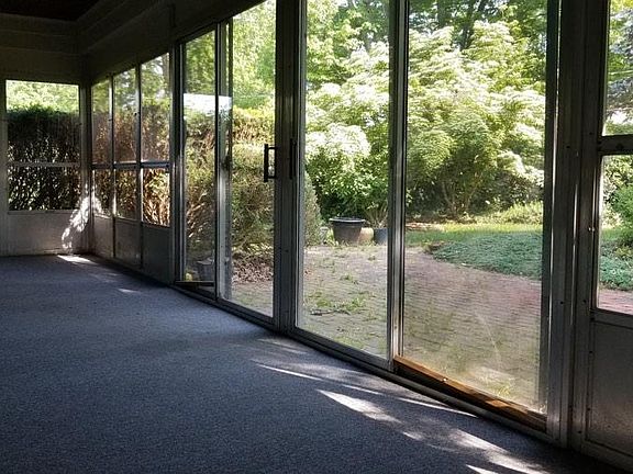 The three seasons screened porch overlooks a beautiful garde
