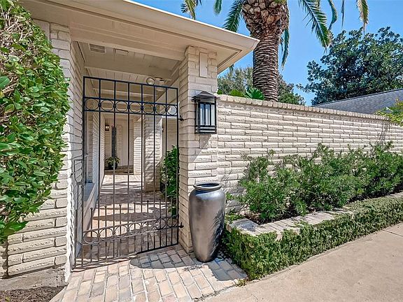 The wrought iron gates welcome you into a hidden gem of a courtyard that will transport you into tranquility.