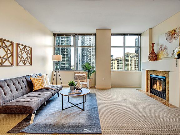 The living room also boasts a cozy fireplace with a large mantle.
