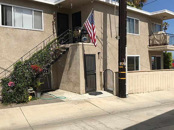 The door to apartment #1 and another gate to the designated patio. The other two apartments are upstairs. The door to the laundry room is under the staircase.