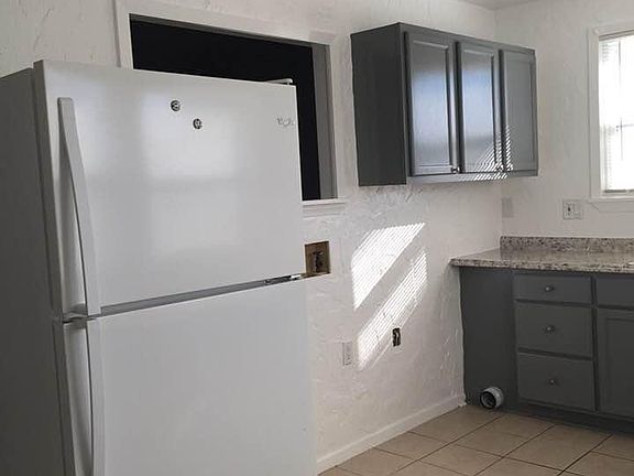 kitchen is 18 x 9 tiled, 4 windows make it bright and cheery