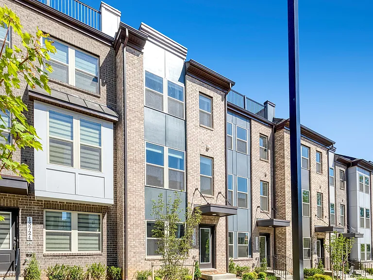 Stunning front exterior showcasing modern design, great curb appeal, and a prime location in the sought-after Quartz District community.