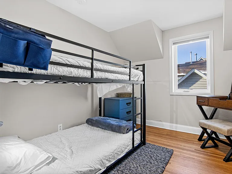 Third bedroom upstairs, currently has a bunk bed and makeup vanity that doubles as a desk