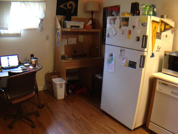 Kitchen with stove, frig, dishwasher.  Hardwood floors.