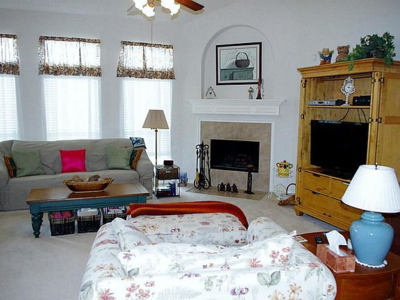 Spacious living room with corner fireplace. (19x18)