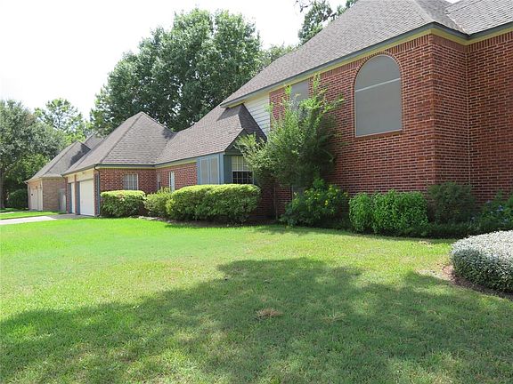 The Home warps around the corner to the 3 Car Garage with mature landscaping.