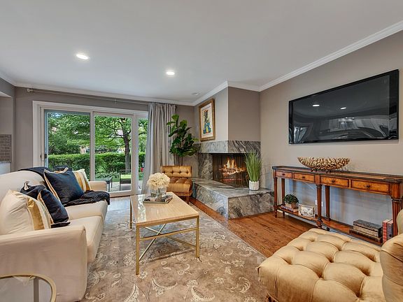 Beautiful Marble Fireplace and Sliders to the Lush Landscape