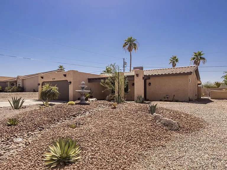 Expansive lot with professionally maintained desert landscaping for low water use and easy upkeep.
