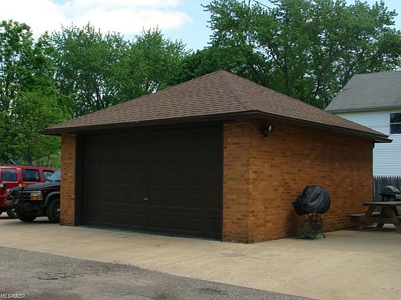 all brick garage with newer door