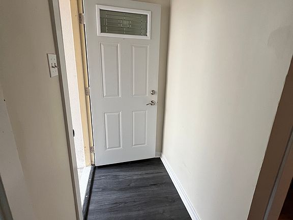 view from inside the unit - new flooring and door open to the courtyard