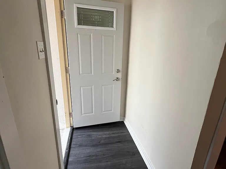view from inside the unit - new flooring and door open to the courtyard