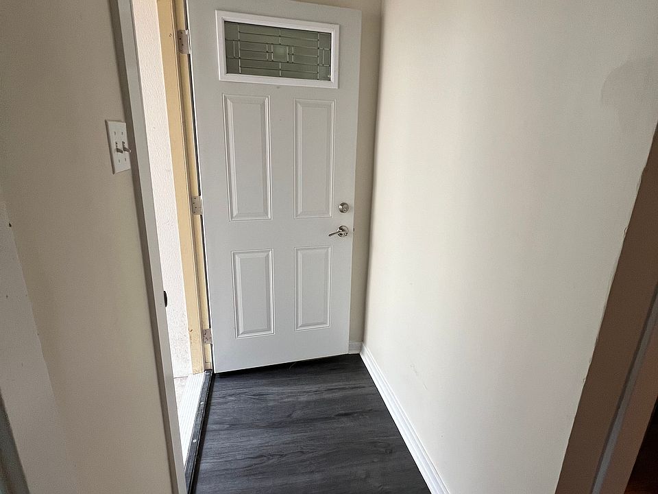view from inside the unit - new flooring and door open to the courtyard