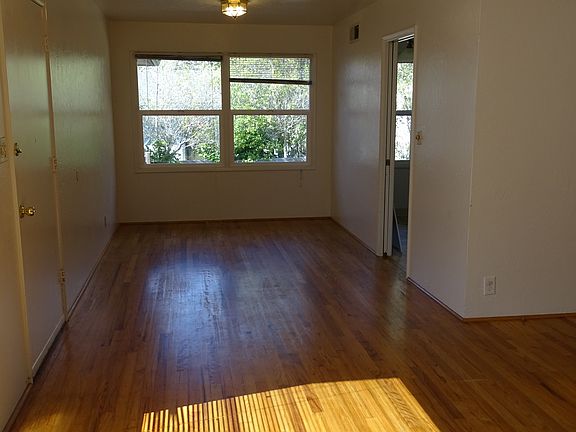 View of dining area and kitchen door from living room