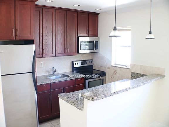 Open Kitchen with white Granite and Cherry Cabinets