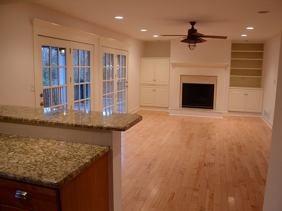 Den with fireplace off of kitchen, entrance to back porch.