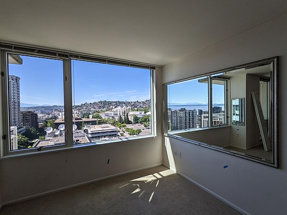 windows knee hight to ceiling. Gorgous Mirror brings the Olympic mountains right 'in' and can be viewed even whilst preparing dinner in the kitchen!! High Ceilings throughout!